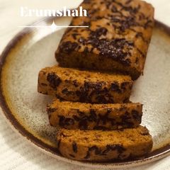 A picture of Banana bread with shredded chocolate on top.