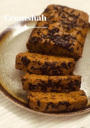 A picture of Banana bread with shredded chocolate on top.
