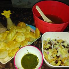 A picture of Gol Gappy with aloo Chana chat and khata and green chutney.