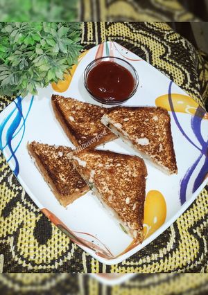A picture of Grilled sandwich with leftover potato vegetable.
