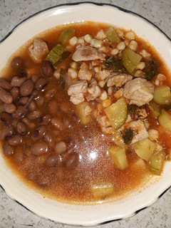 A picture of Pork with Zucchini and Corn.