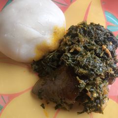 A picture of Vegetable soup and fufu swallow.