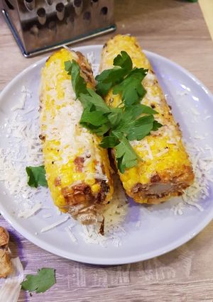A picture of Cheesy, garlicky corn on the cob.