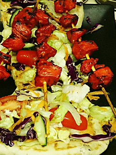 A picture of Tex's Chicken Tikka Kebab on Naan Bread 🐔🍞🍲🌿.