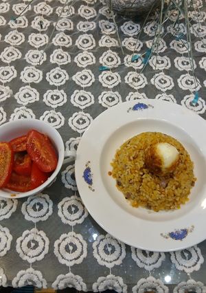 A picture of Alexandrian Koshari with Rolled Eggs, Salted Tomatoes, and Dukka.