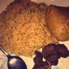 A picture of Jollof rice wit moi moi.