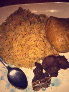 A picture of Jollof rice wit moi moi.