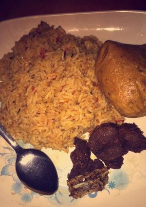 A picture of Jollof rice wit moi moi.