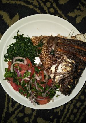 A picture of Kachumbari with fish and greens.