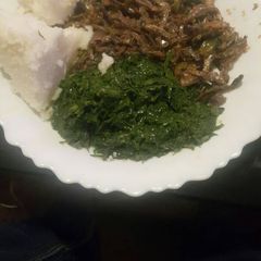 Omena fried with greens and ugali A picture of Omena fried with greens and ugali.