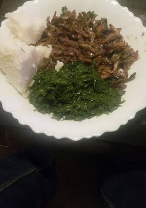 A picture of Omena fried with greens and ugali.