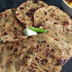 A picture of Dry Methi Leaves In Missi Roti On Tava.