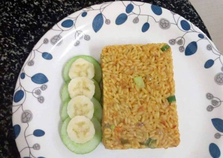 Jollof rice served with cucumber and banana