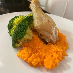 A picture of Baked Chicken Drumstick Served with Carrot Puree and Blanch Broccoli.