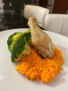 A picture of Baked Chicken Drumstick Served with Carrot Puree and Blanch Broccoli.
