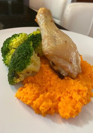 A picture of Baked Chicken Drumstick Served with Carrot Puree and Blanch Broccoli.