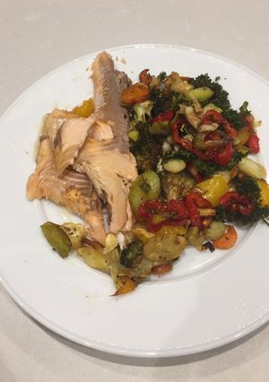 A picture of Baked trout and vegetables.