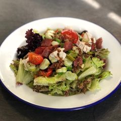 A picture of Basque sausage, goats cheese, broad bean and spring onion salad.