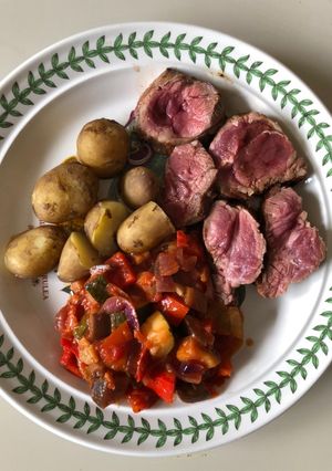 A picture of Fillet of lamb with ratatouille and Jersey Royal potatoes.
