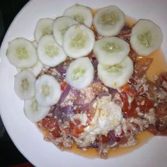 A picture of Fried eggs with cucumber.