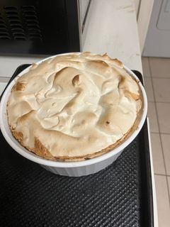 A picture of Southern blueberry buttermilk biscuits bread pudding with blueberry sauce.