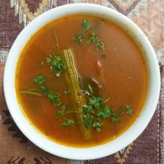 A picture of Drumstick and Tomato Rasam.