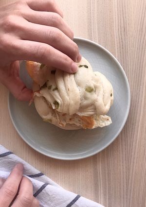 A picture of Spring onion bun with pan fried egg 🍳.