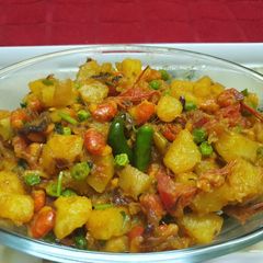 A picture of Prawns with Potato and Green Peas.