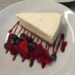 A picture of Cheese cake with berry compote.