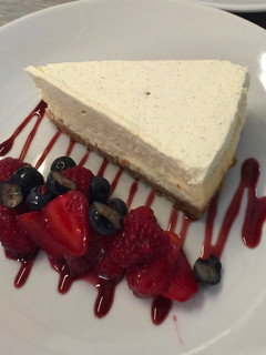 A picture of Cheese cake with berry compote.