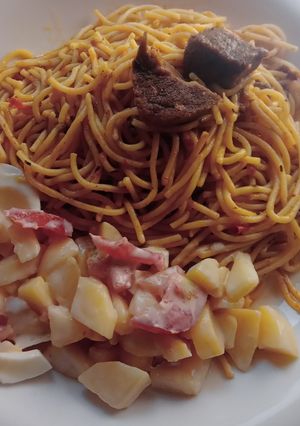 A picture of Jollof spaghetti with beef and potato salad.