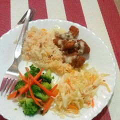 A picture of Rice, fish fingers and mixed vegetables.