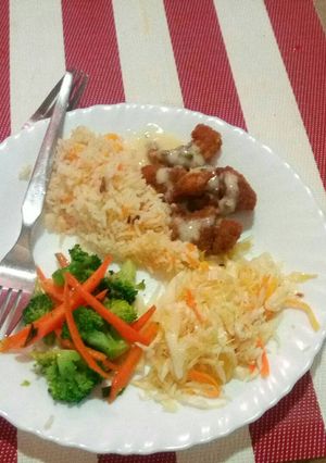 A picture of Rice, fish fingers and mixed vegetables.