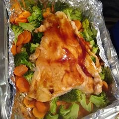 A picture of Salmon with vegetables.