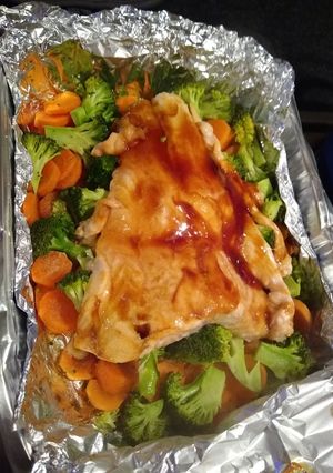A picture of Salmon with vegetables.