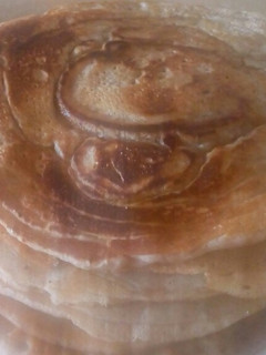 A picture of Nutmeg Pancakes drizzled Maple Syrup# Author Marathon.