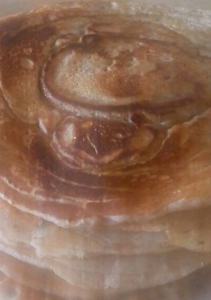 A picture of Nutmeg Pancakes drizzled Maple Syrup# Author Marathon.