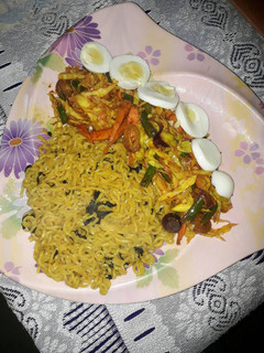 A picture of Noddles, stir fried vegetables and boiled egg.