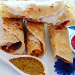 A picture of Chicken roll with curd sauce.