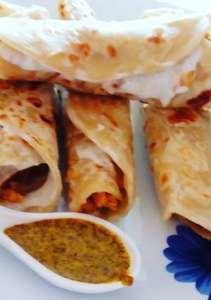A picture of Chicken roll with curd sauce.