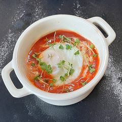 A picture of Freddy’s Poached egg with a sweet pepper sauce.