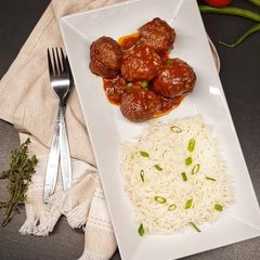 A picture of Meatballs in tomato and red wine sauce.