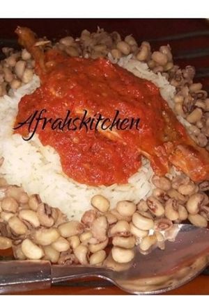 A picture of Rice and beans with stew.