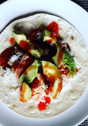 A picture of Salmon and avocado enchilada.