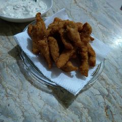 A picture of Chicken Fingers with creamy sauce.