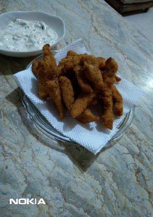A picture of Chicken Fingers with creamy sauce.