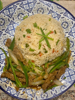 A picture of Beef chilli with egg fried rice.