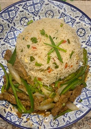 A picture of Beef chilli with egg fried rice.