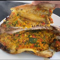 A picture of Grilled Tilapia with Special Thai Paste (lemongrass, chili, coriander root, with turmeric).