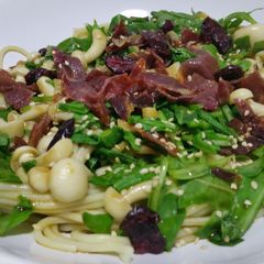 A picture of Pasta with rocket, mushrooms and crunchy ham.